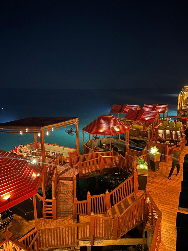Sajjad Restaurant aerial chalets over Arabian Sea at night