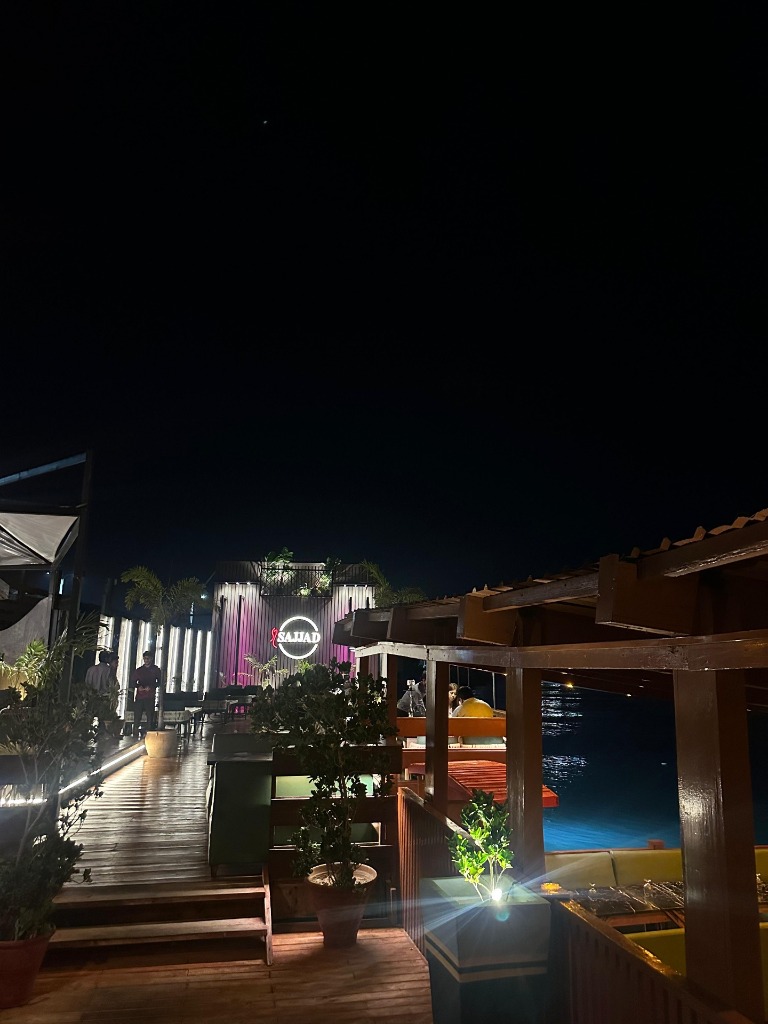 The open-air dining deck at Sajjad Restaurant overlooking the sea